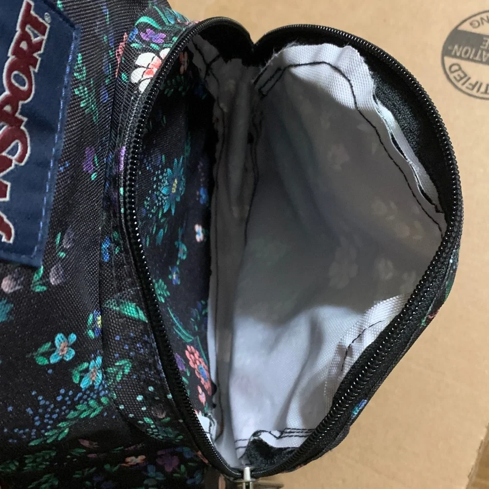 Jansport Black Mini Backpack with Pink, Purple & Green Floral Print.
